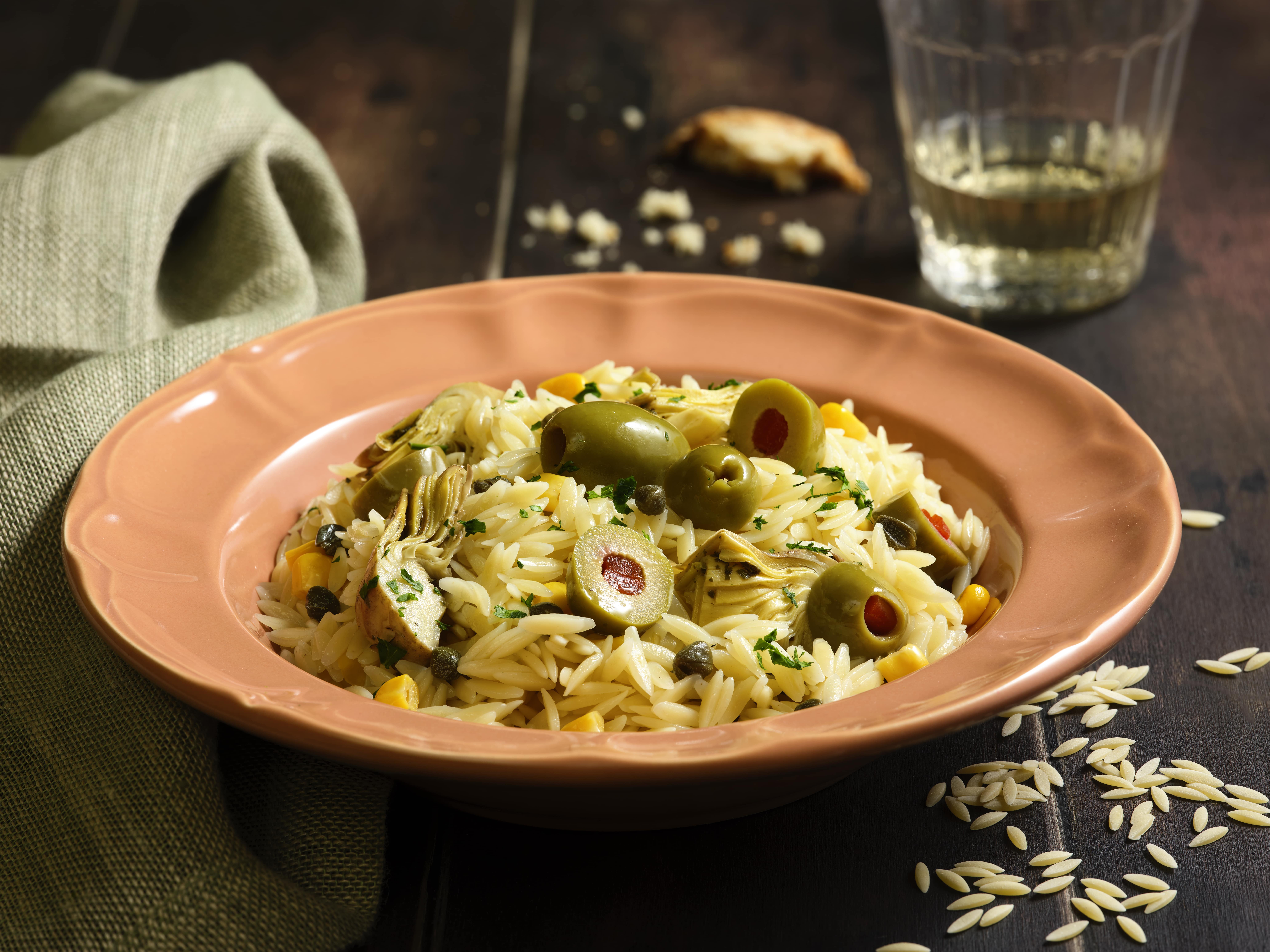 Orzo pasta salad with corn, stuffed olives, cappers, grilled artichokes, herbs